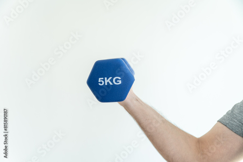 Arm lifting a dumbbell against a plain white background