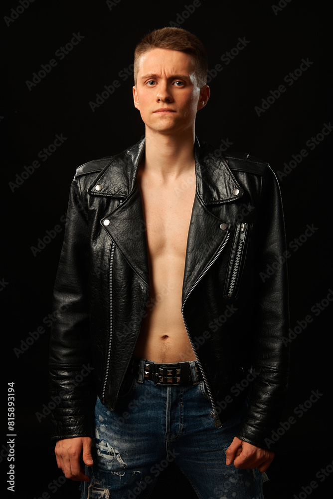 Portrait of a rock band member. Bass guitarist. Photo on a black background. Grain effect used Portrait of a rock band member. Bass guitarist. Photo on a black background. Grain effect used