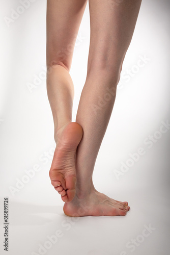 slender long female legs on a white background