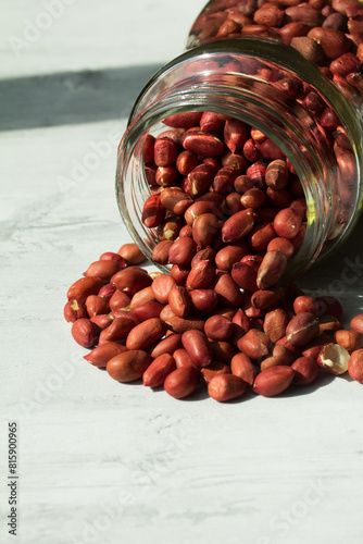 Macro shot of peanuts inside a glass jar.