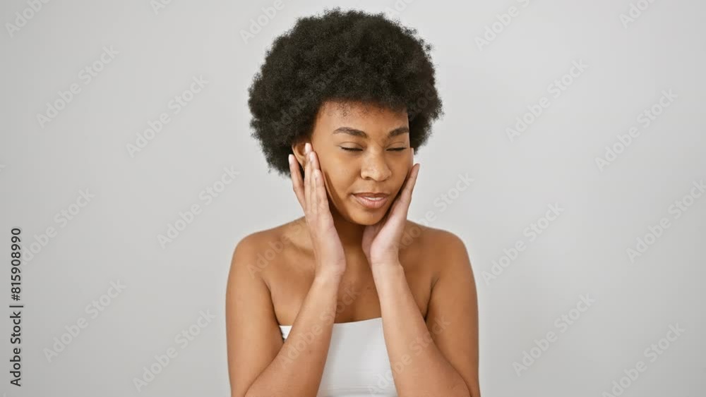 A radiant african woman with curly hair, smiling in a white tube top against an isolated white backdrop. A radiant african woman with curly hair, smiling in a white tube top against an isolated white backdrop.