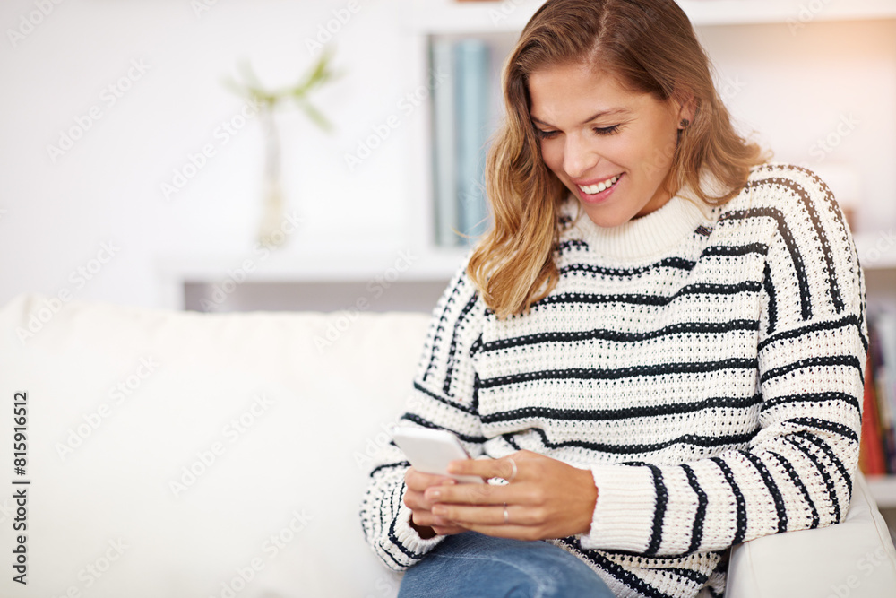 Woman, phone and texting on sofa in home with smile for notification, reading or funny meme on web. Girl, person and smartphone with mobile app, social media and streaming video on couch in lounge