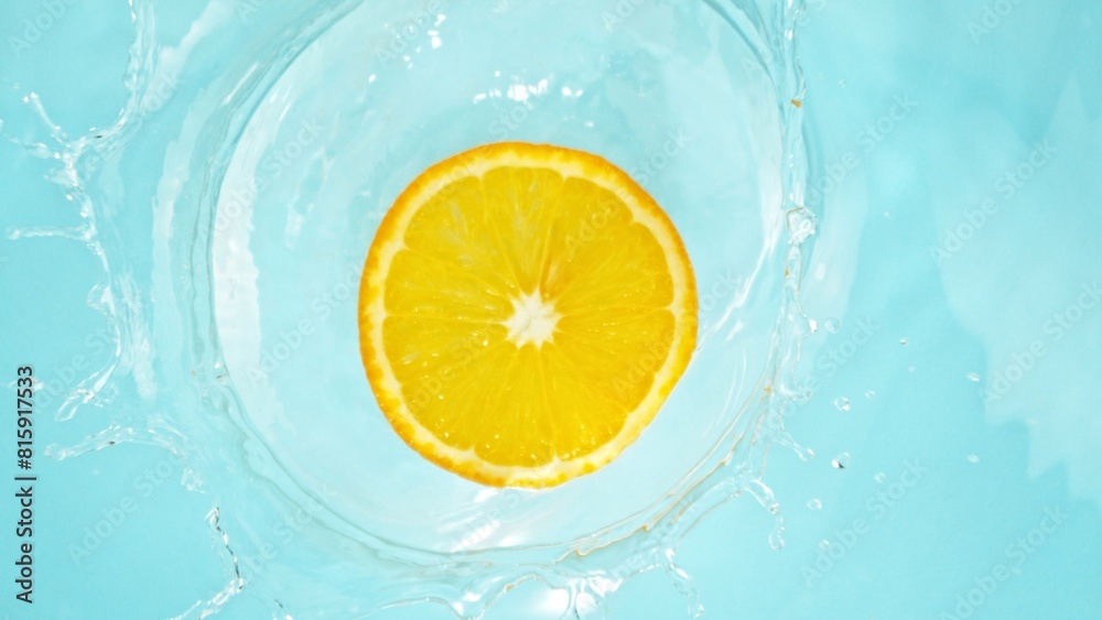 Freeze Motion of Orange Slice Falling into Water, Splashing. Freeze Motion of Orange Slice Falling into Water, Splashing.