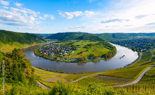 Panorama of the 180 degree river loop of the Moselle between Kröv and Traben-Trabach located in a popular wine-growing region in Germany. Wide angle perspective in the light of the evening sun in May.