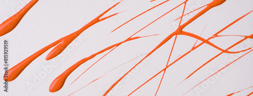 Thin orange lines and splashes drawn on white background. Abstract art backdrop with ginger brush stroke.
