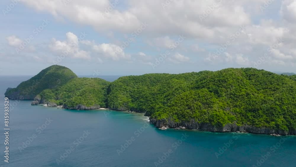 Island with lush foliage, green plants surrounded by blue sea. Inambuyod Island. El Nido, Palawan. Philippines. Island with lush foliage, green plants surrounded by blue sea. Inambuyod Island. El Nido, Palawan. Philippines.
