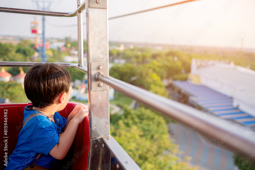 Cute little boy enjoying ride in cable car with parent. Children have activities with Family concept. Selective focus. Copy space. Cute little boy enjoying ride in cable car with parent. Children have activities with Family concept. Selective focus. Copy space.