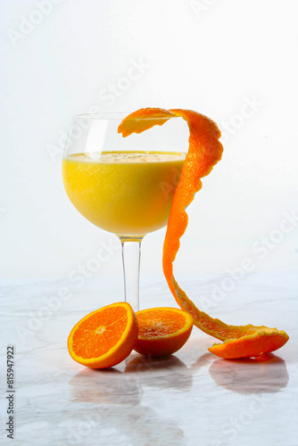 Eat with orange juice with orange peel to decorate on a marble background..