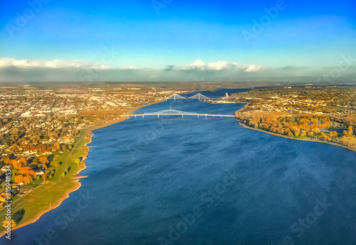 Aerial view of the Columbia River flowing under bridges connecting the Tri-Cities of Pasco, Kennewick, and Richland in Washington State photo