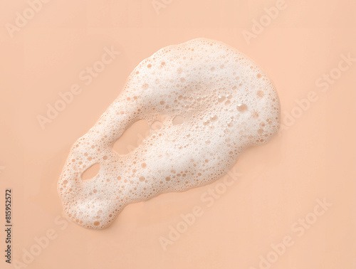 White skincare cleansing foam swatch on peach background