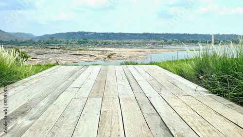 Balcony wooden table refreshing atmosphere with blurred background of mountains and rivers.