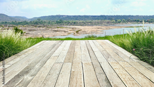 Balcony wooden table refreshing atmosphere with blurred background of mountains and rivers.