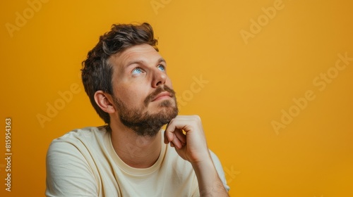 Man Contemplating on Yellow Background photo