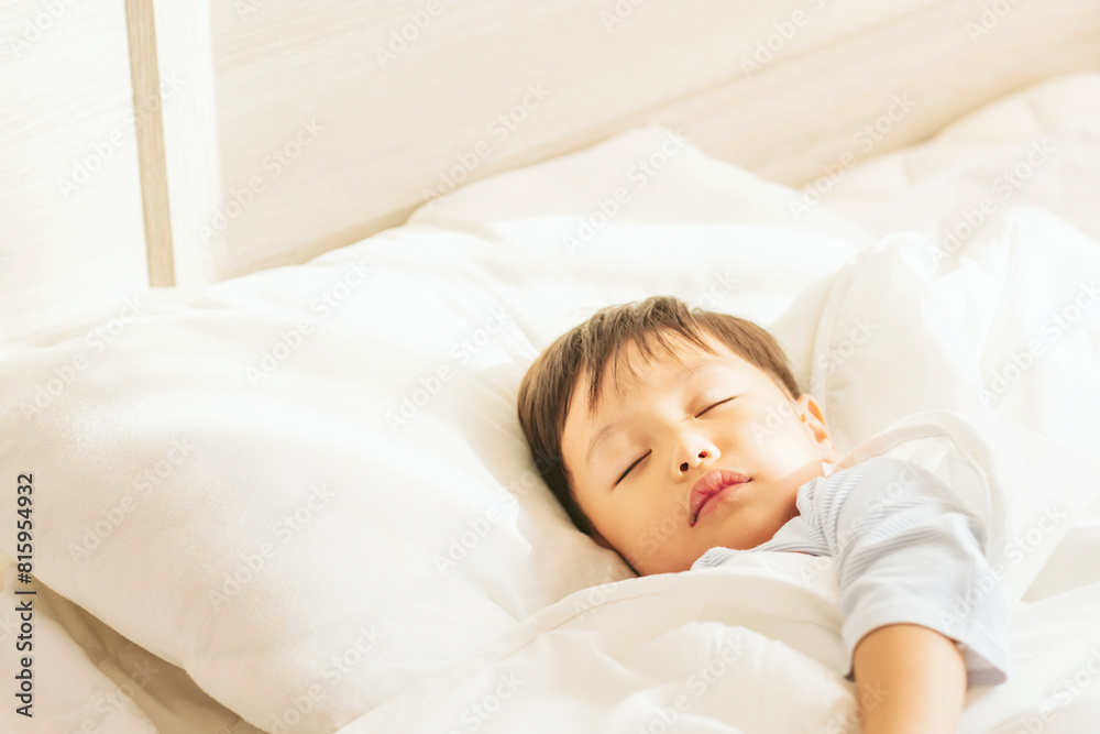 Happy asian cute boy sleeping with the penguin doll. Dreaming concept. Soft focus. Copy space. Happy asian cute boy sleeping with the penguin doll. Dreaming concept. Soft focus. Copy space.