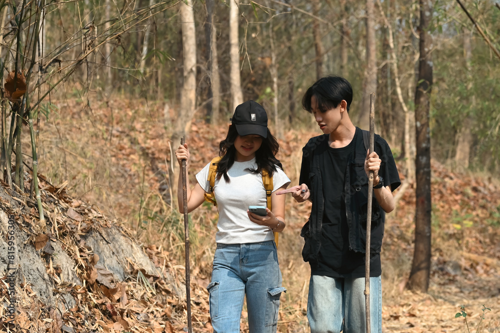 Fototapeta premium Close-up image of a Young LGBT couple searching for a direction to begin their journey, LGBT people, and leisure activity concept