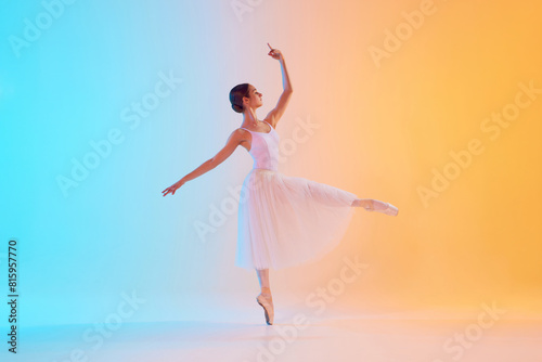 Graceful, tender ballerina performing pirouette in motion in neon light against blue-orange gradient background. Concept of art, movement, classical and modern fusion, beauty and fashion. Ad