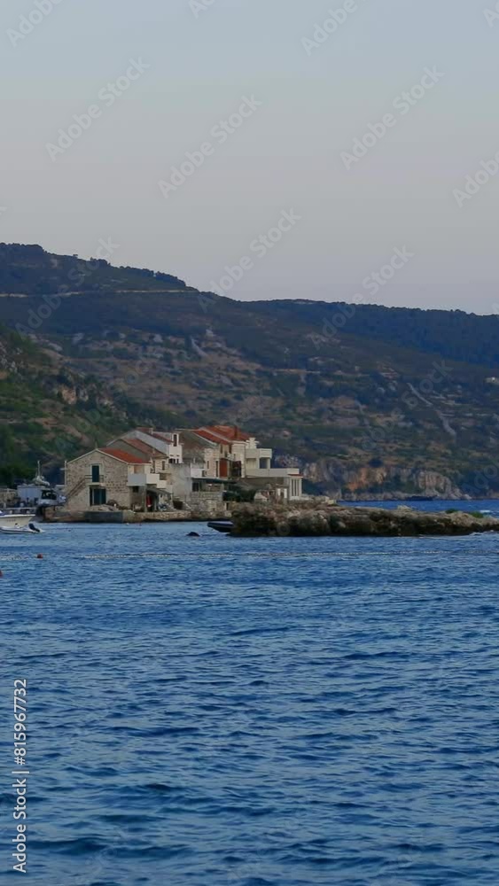 The rocky coast of one of the Croatian islands in the summer. Vertical Video The rocky coast of one of the Croatian islands in the summer. Vertical Video