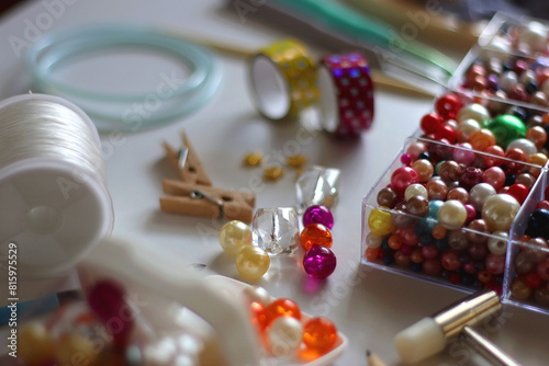 Various craft supplies on white background. Supplies for jewelry making, drawing and needlework. Selective focus.