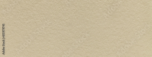 Texture of old light beige color paper background, macro. Structure of a vintage craft sand cardboard.