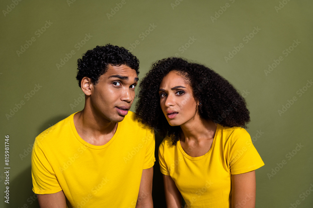 Portrait of two nice people think doubt wear t-shirt isolated on khaki color background Portrait of two nice people think doubt wear t-shirt isolated on khaki color background