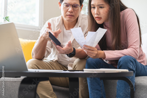 Stressed financial owe asian young couple love sitting suffer, stressed and confused by calculate expense from invoice or bill, no money to pay, mortgage or loan. Debt, bankrupt or bankruptcy people