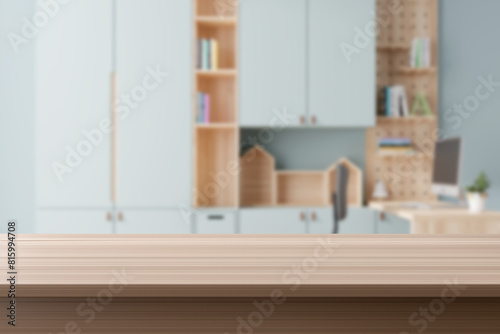 An empty wooden tabletop foregrounds a softly blurred child's learning space, ideal for product display and back-to-school themes. Desk front view. 3D render.