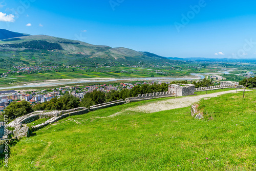 A panorama view over the castle walls towards the Osum river as it approaches the city of Berat, Albania in summertime