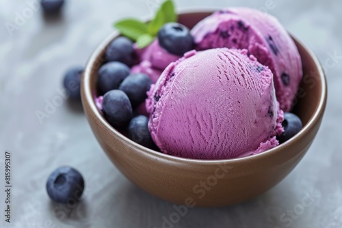 Delicious blueberry ice cream served with fresh berries in a ceramic bowl