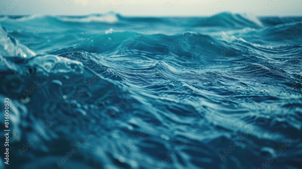 Closeup of stunning deep blue ocean water with gentle waves on seascape background