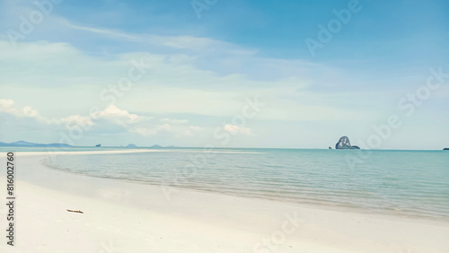 Long curved smooth sandy beach and island views. The beauty of tropical nature. Sea tourism. © Win Nondakowit
