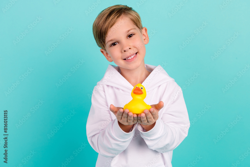 Photo of adorable kid share gift bathroom animal duck isolated on cyan color background Photo of adorable kid share gift bathroom animal duck isolated on cyan color background
