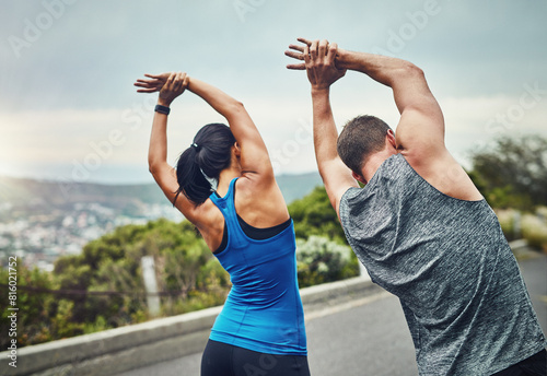 Training, couple and stretching arms outdoor in morning for benefits to health, wellness and fitness. People, prepare and start exercise with resilience in summer challenge or flexible muscle in back