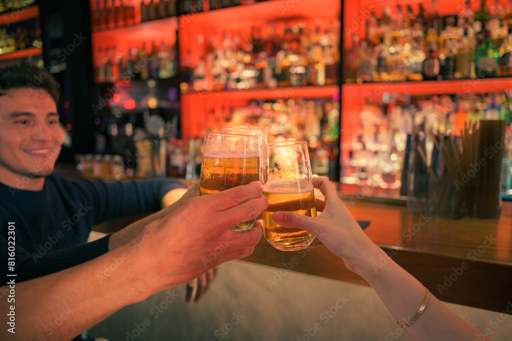 Friends toasting with drinks at a lively bar in the evening Friends toasting with drinks at a lively bar in the evening