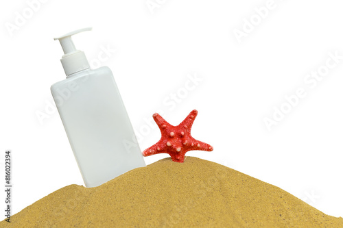 White container for lotion with a red starfish on the sand. Place for text.