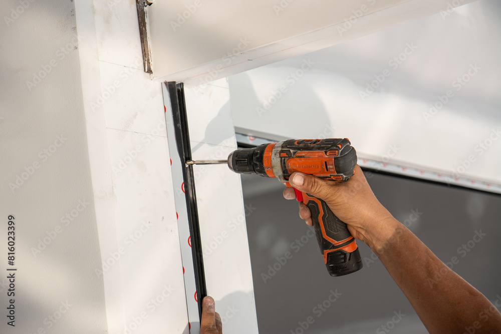 man use electrical drill to drilling square steel bar man use electrical drill to drilling square steel bar