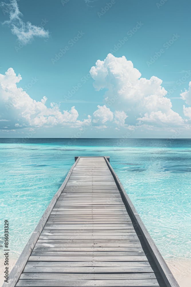 Fototapeta premium wooden beach pier leading into turquoise water of the maldives