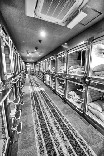 Tokyo, Japan - June 1st, 2016: Interior of Capsule Hotel with tiny rooms for guests along a long corridor photo