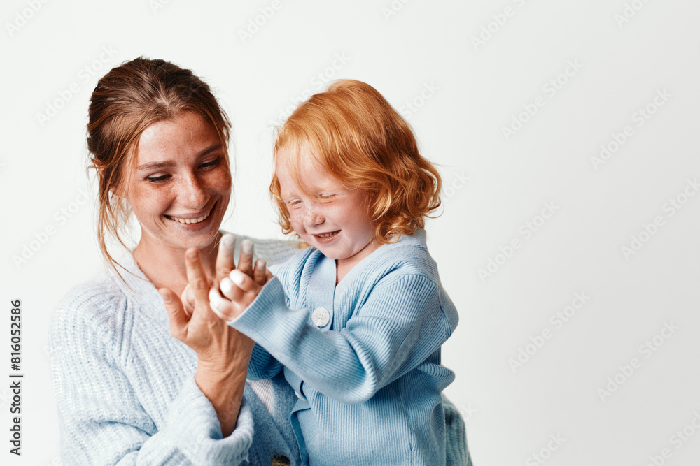 Mother and daughter embracing in joyful moment on white background with smiles love, family, togetherness and happiness concept