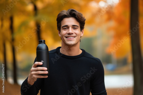 man showing black deodorant bottle
