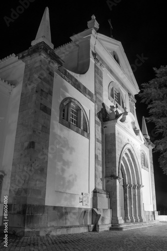 Black and white image of the Church of Santa Maria do Castelo lit up at night, Tavira, Portugal