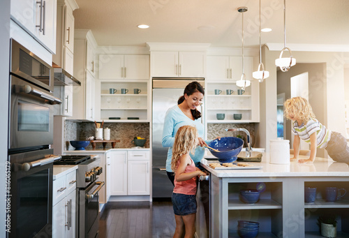 Mother, children and cookies in home for baking with learning, bonding and preparation in kitchen with teaching. Family, woman and kids with cooking dessert, cake and sweet snack with fun in house © peopleimages.com