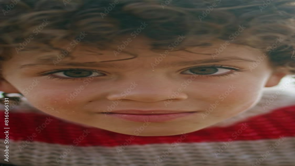 Closeup curly kid posing at cloudy sky. Adorable little boy resting vertical 