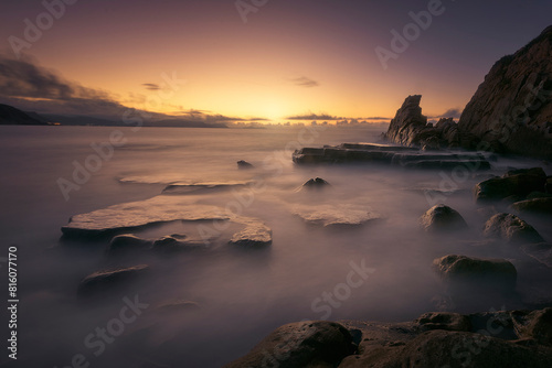 Sunset on Azkorri or Gorrondatxe beach  in Getxo  Bizkaia  with the waves passing over the rocks