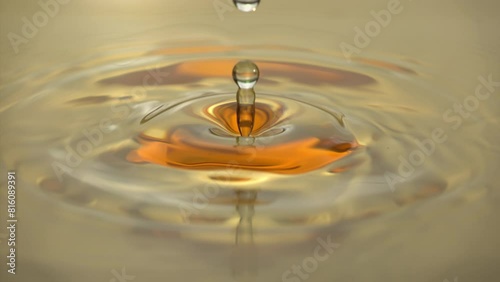 Cosmetics golden serum liquid. Falling drop macro abstract background. Cosmetic moisturizer essence gel. Collagen fluid bubble molecule. Yellow moisturizing cream oil. Beauty skin health care concept
