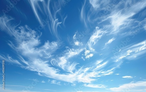 Expansive blue sky with delicate wispy clouds.