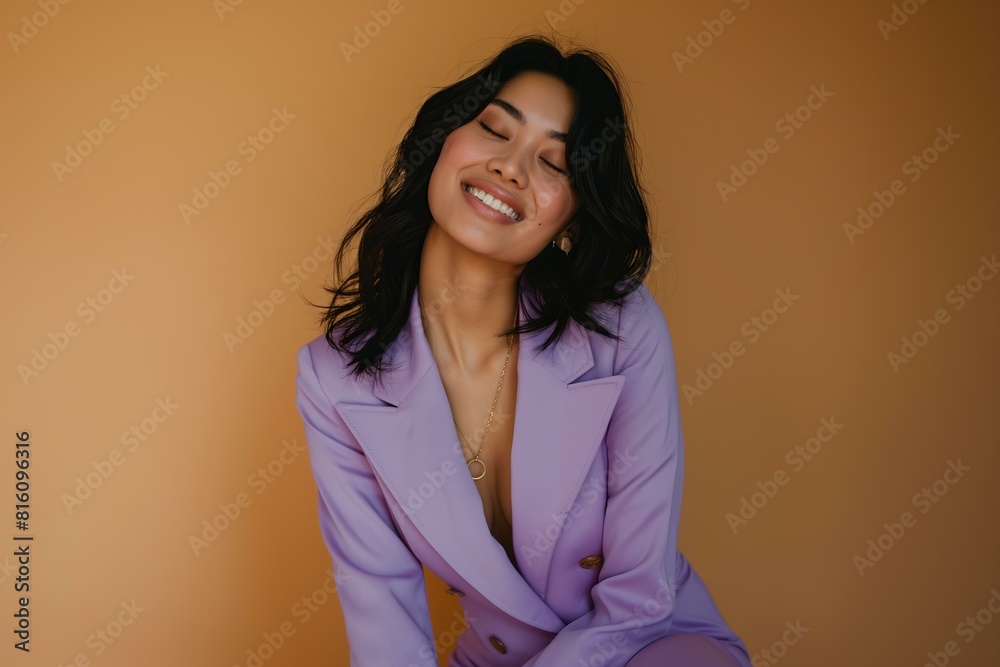 smiling woman with black hair wearing pastel purple summer suit, brown solid color background smiling woman with black hair wearing pastel purple summer suit, brown solid color background