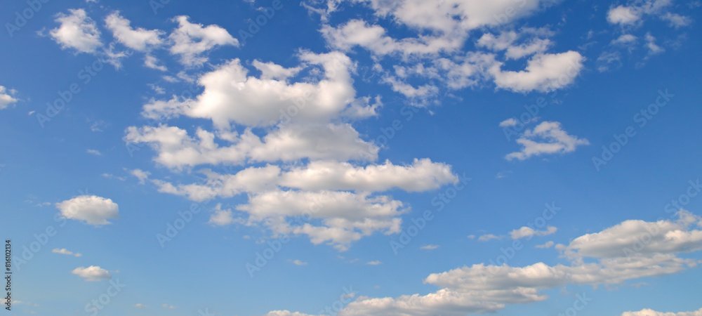 Blue sky and cumulus clouds. Wide photo. Blue sky and cumulus clouds. Wide photo.