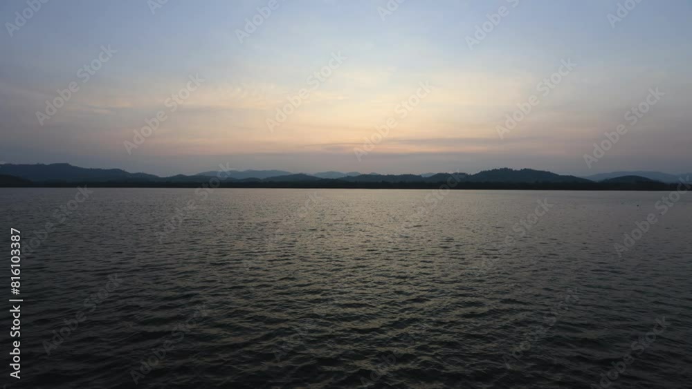 High angle video background with mountain scenery The river and the beautiful sunshine blurred onto the water surface in a golden light, the beauty of nature during the trip. High angle video background with mountain scenery The river and the beautiful sunshine blurred onto the water surface in a golden light, the beauty of nature during the trip.