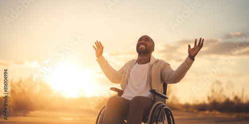 Happy handsome young African american disabled man on a wheelchair praising the lord. sunset outdoors. Enabling Smiles: Healing Through Adaptive Living.