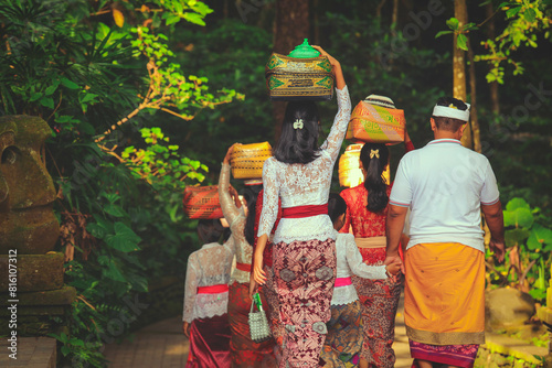 Soft focus on women carrying basket on the head during the celebration in Ubud, Bali, Indonesia
